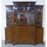 Mahogany breakfront cabinet bookcase, the pediment top over four astragal glazed doors with