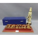 Chinese soapstone carving of Guanyin with a stylised hardwood base, height excluding base 26cm,