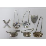 Various decanter labels to include two silver, two porcelain, one Epns and a white metal shield