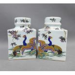 Pair of white glazed square form vases with covers, decorated with peacocks and blossom, 17cm (2)