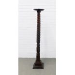 Mahogany torchere of tall proportions with a circular dished top on a barely twist column and