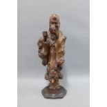 Rootwood carved figure of a Sage on a circular base, 32cm