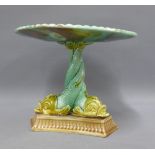 Majolica centrepiece, the shell comport raised on a dolphin supports with a triform base, repaired