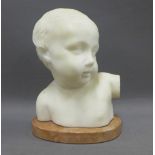 White hardstone head and shoulders bust of a young child on an pink oval marbled base, 22cm