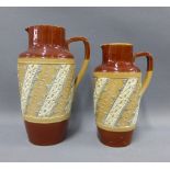 Two late 19th century Doulton jugs of graduating size, tallest 23cm (2)