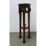 Renaissance style mahogany jardiniere planter with a circular top with mask heads and swags, the