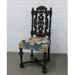 Dark oak side chair with leaf carved top rail and turned uprights with a floral upholstered seat, on