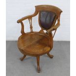 Early 20th century oak captains chair with Jenners Edinburgh label, with leather upholstered back,