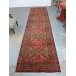 Persian runner, red field with six medallions and multiple borders, 422 x 115cm