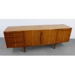 Mid-century McIntosh sideboard with a pair of cupboard doors flanked by three drawers and a single