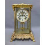 Early 20th century brass and glass panelled mantle clock, the chapter ring with Roman numerals,
