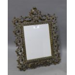 Bronze framed mirror with a pierced frame and rectangular plate and strut back, overall size 44 x