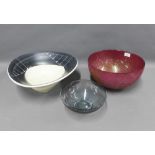 Contemporary red and gold glass bowl, black and white pottery bowl and a smoked glass bowl,