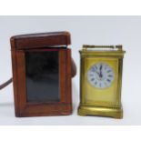 Brass and glass panelled carriage clock, black Roman numerals on a floral decorated dial, with