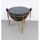 A tribal war drum table contained within a gilt metal base, complete with beaters, 74 x 63cm