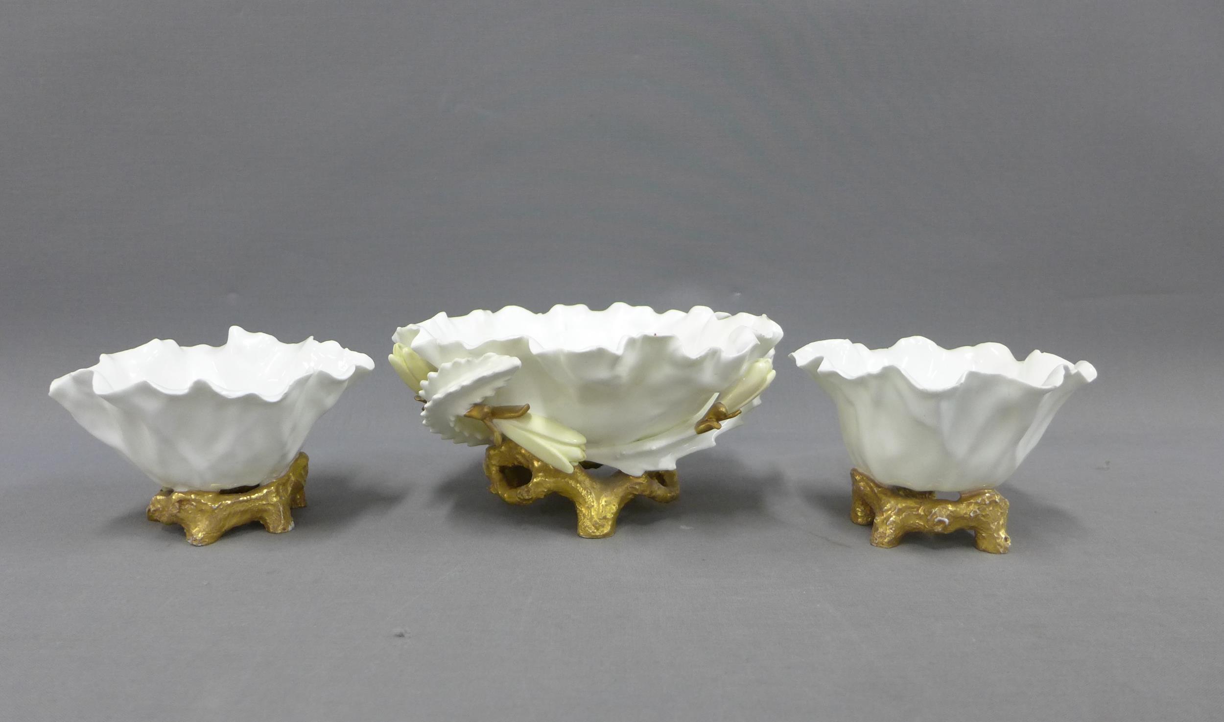 Moore Bros garniture of white glazed porcelain posy vases, largest 18cm long (3)