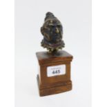 Bronze head and shoulders bust of a man on a wooden plinth base, 18cm high