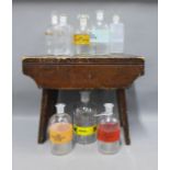 A set of eight vintage pharmacy glass bottles and a milking stool (9)