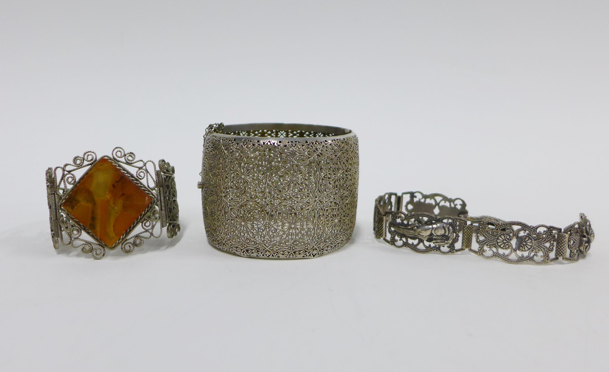 Two white metal filigree bracelets and a another, (3)