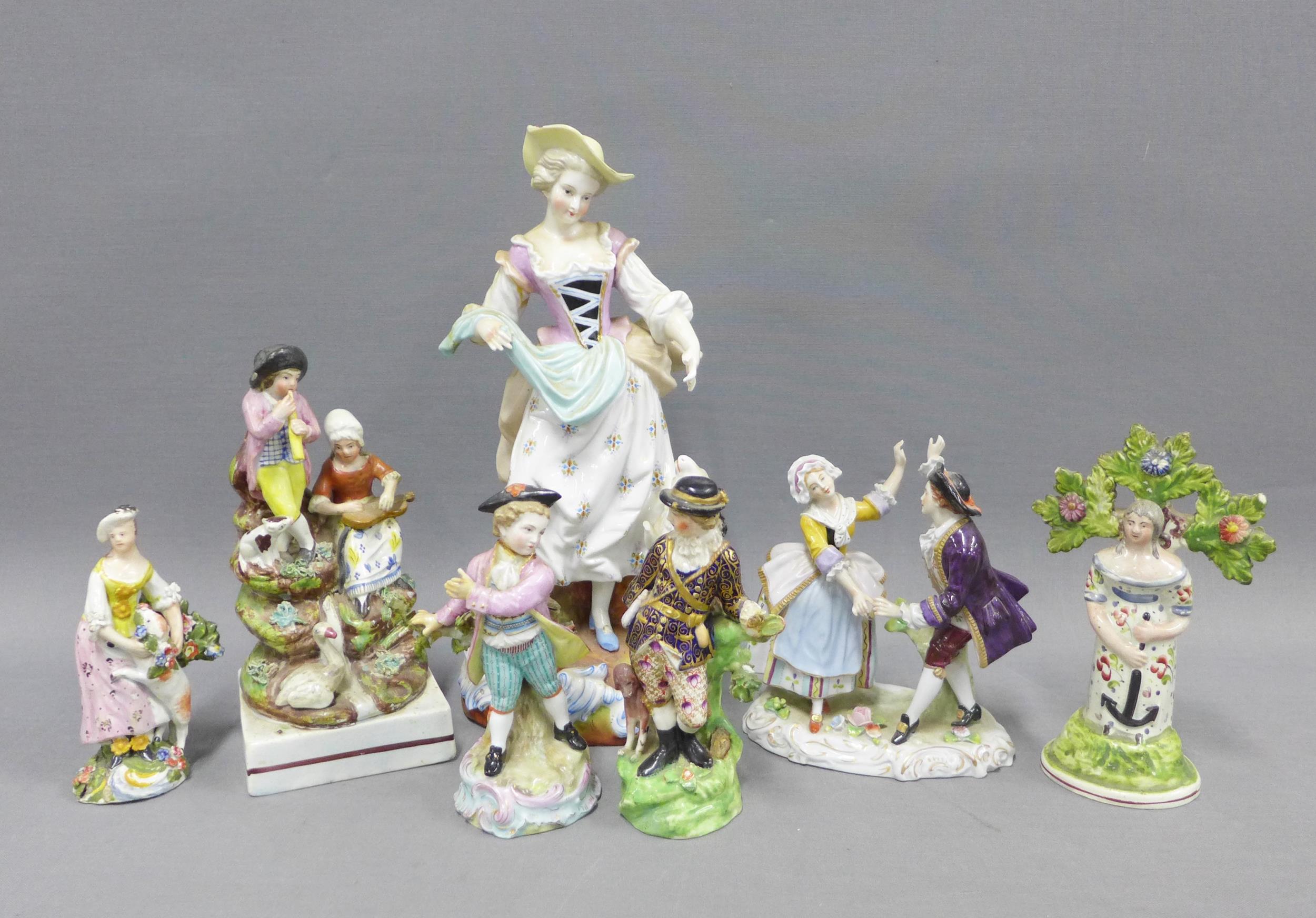 A group of Staffordshire pottery and continental porcelain figures to include a pearlware figure
