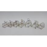 Seven early 20th century silver toast racks, to include Chester & London hallmarks, 9cm high (7)