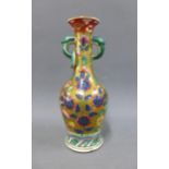 Famille verte bottle neck vase with serpent handles and a gilded ground painted with dragon
