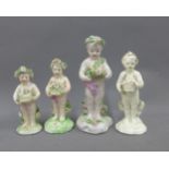 Collection of 19th century pottery cherubs together with a creamware cherub, all with flowers,