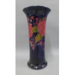 Moorcroft vase in Pomegranate pattern against a blue ground, with impressed facsimile signature