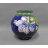 Moorcroft vase in Clematis pattern against a blue ground, impressed facsimile signature and