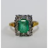 18ct gold emerald and diamond cocktail ring, claw set with a step cut emerald within a surround of