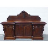 Victorian mahogany inverted breakfront sideboard, with a fruit and leaf carved ledgeback over four