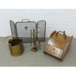 Late 19th and early 20th century fireside accessories to include an oak purdonium, a brass fire