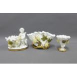 Moore Bros white glazed porcelain posy vases, one with a cherub and Greek Key base and two encrusted