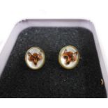 A pair of 18ct gold fox head painted glass earrings, stamped 18ct