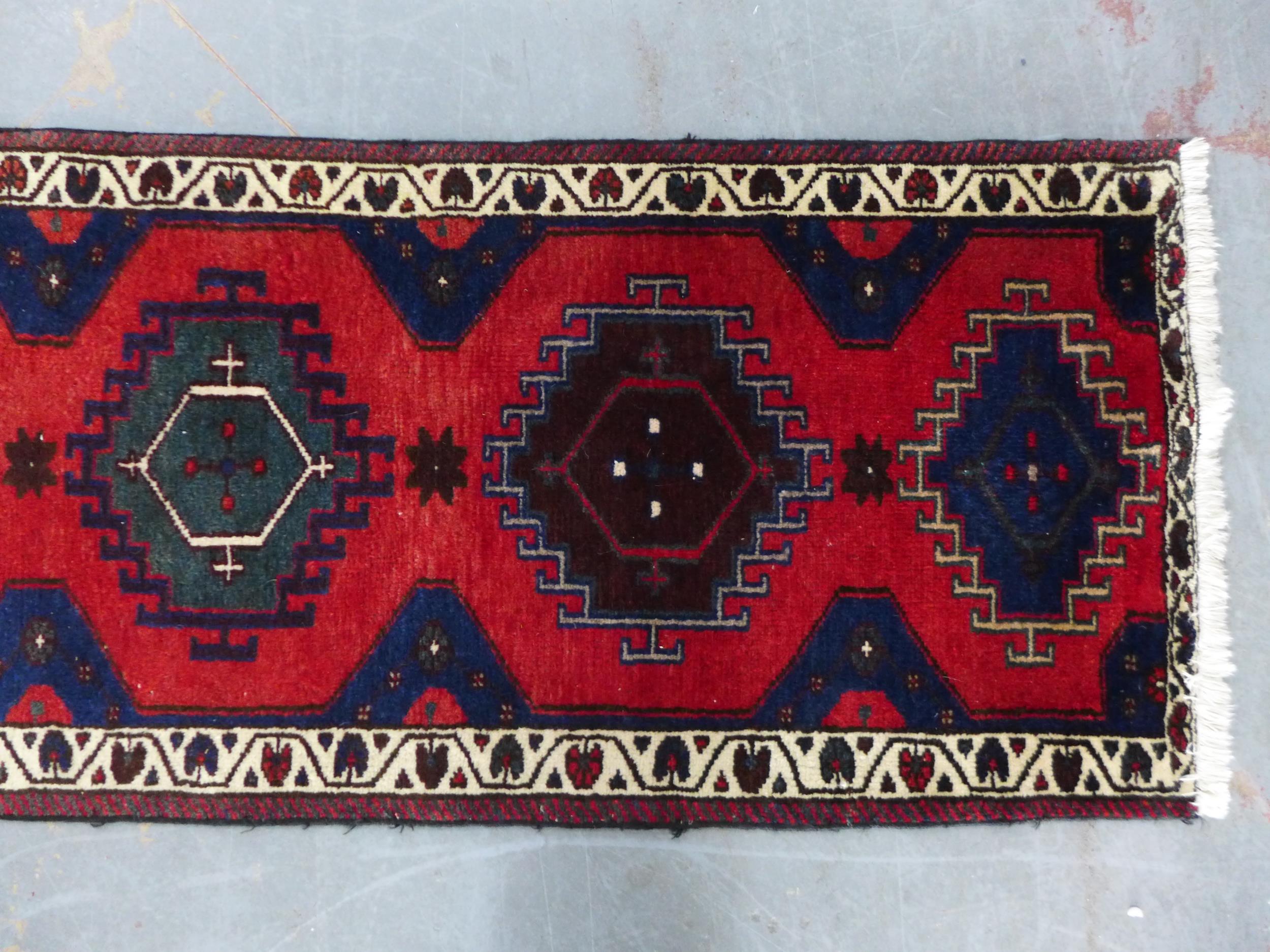 Kazak style runner with red field and seven medallions, 290 x 74cm - Image 2 of 5