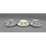 A pair of Chinese famille rose cups and saucers and a Royal Worcester Dr Walls commemorative cup and