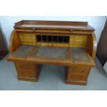 Large Victorian mahogany roll-top pedestal desk, with satinwood fitted interior, pull out slide