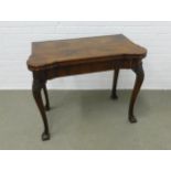 Mahogany card table, cross banded with quarter veneers, rounded corners and green skiver, carved
