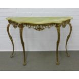 A vintage console table, with serpentine top and raised on faux brass cabriole legs with paw feet,