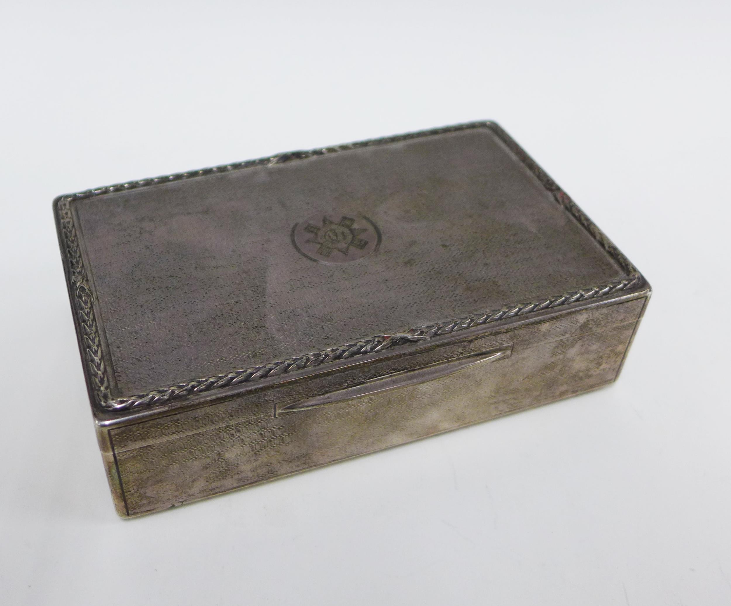 George V Scots Guards silver table cigarette box, with engine turned decoration and laurel leaf