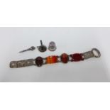 Silver and banded agate dagger brooch and a white metal bracelet with coloured hardstone panels,