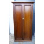 Mahogany wardrobe / cupboard of small proportions, stepped cornice over a pair of panelled doors,