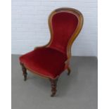 Victorian mahogany spoonback nursing chair, upholstered in red velvet, with brass caps and ceramic