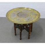 Brass and white metal inlaid Benares table on folding wooden stand, 70 x 50cm