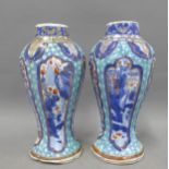A pair of Chinese lobed vases with underglaze blue and white ground and figural panels with stylised