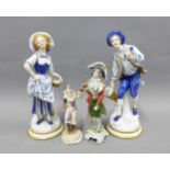 A pair of Continental porcelain blue and white figures and two smaller figures, tallest 22cm (4)