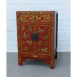 Red lacquered chinoiserie cabinet, single drawer over two doors decorated with with flowers and