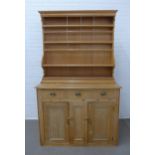 Pine kitchen dresser, with a shelved plate back above three drawers and two cupboard doors, (plate