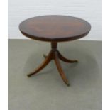 Mahogany breakfast table on pedestal base terminating with brass castors, 100 x 76cm