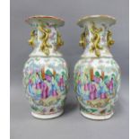 A pair of Chinese famille rose vases, one restored, 24cm high (2)